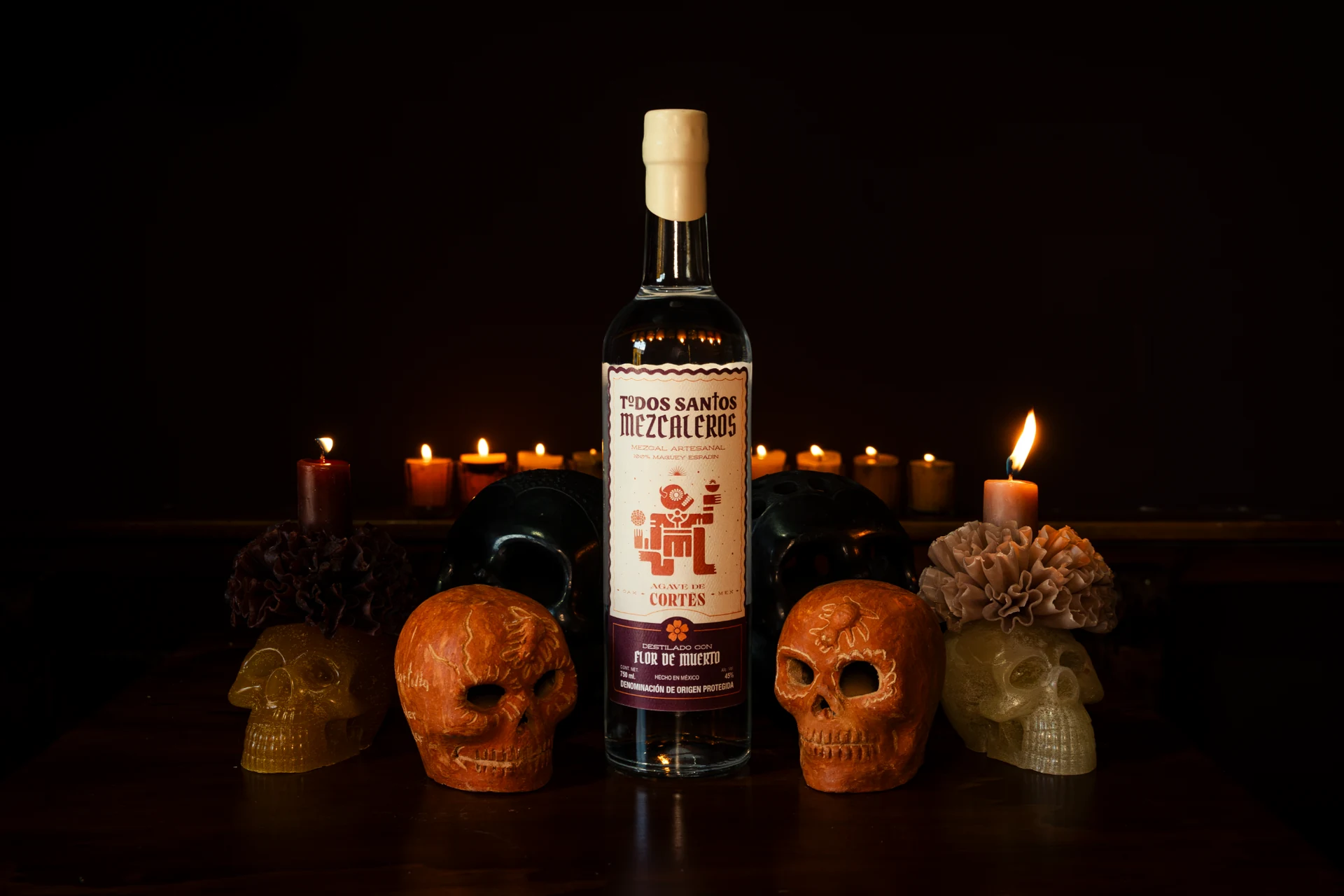 Botella de Todos Santos Mezcaleros en una ofrenda con velas